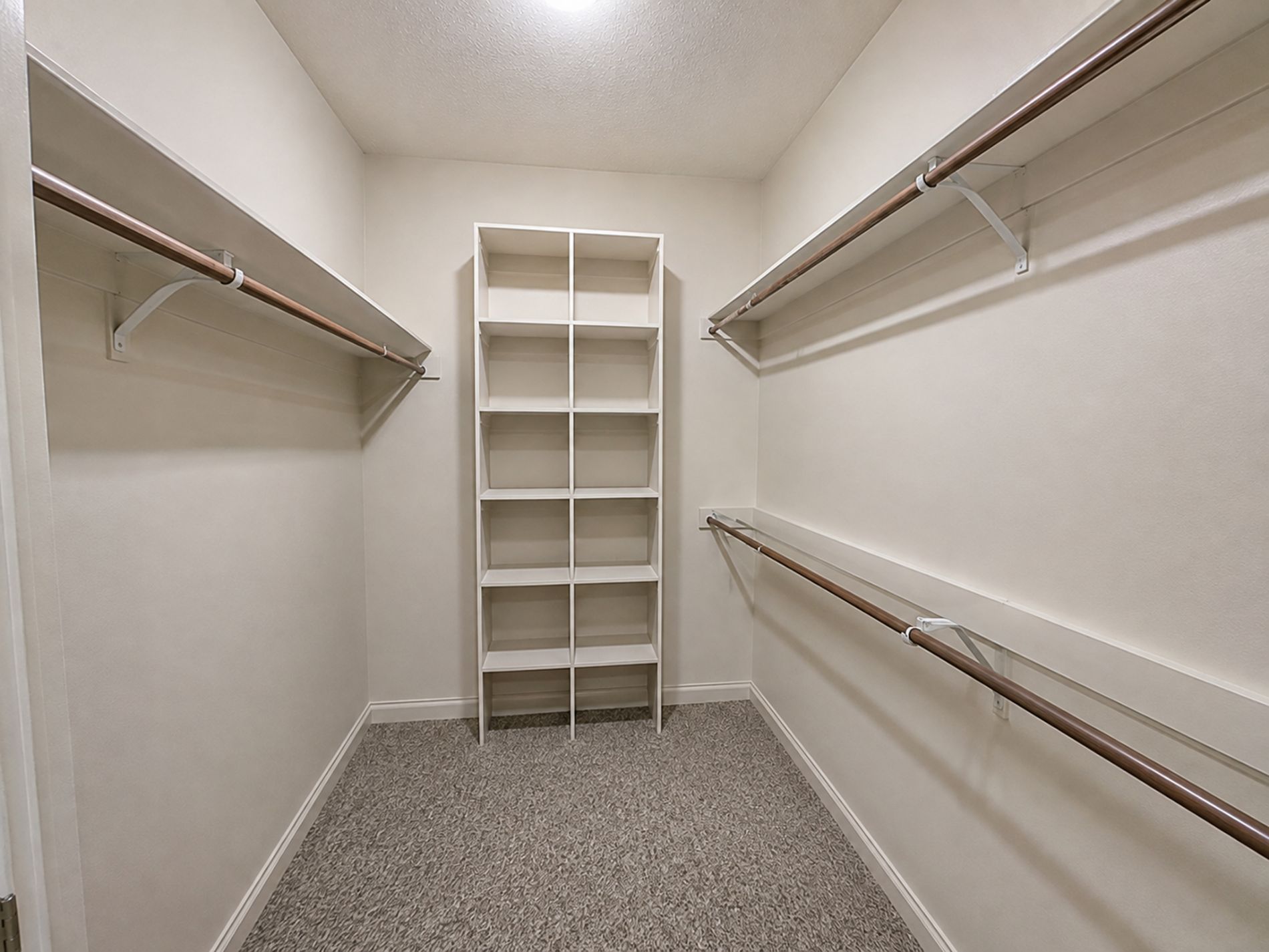 Primary bedroom walk-in closet