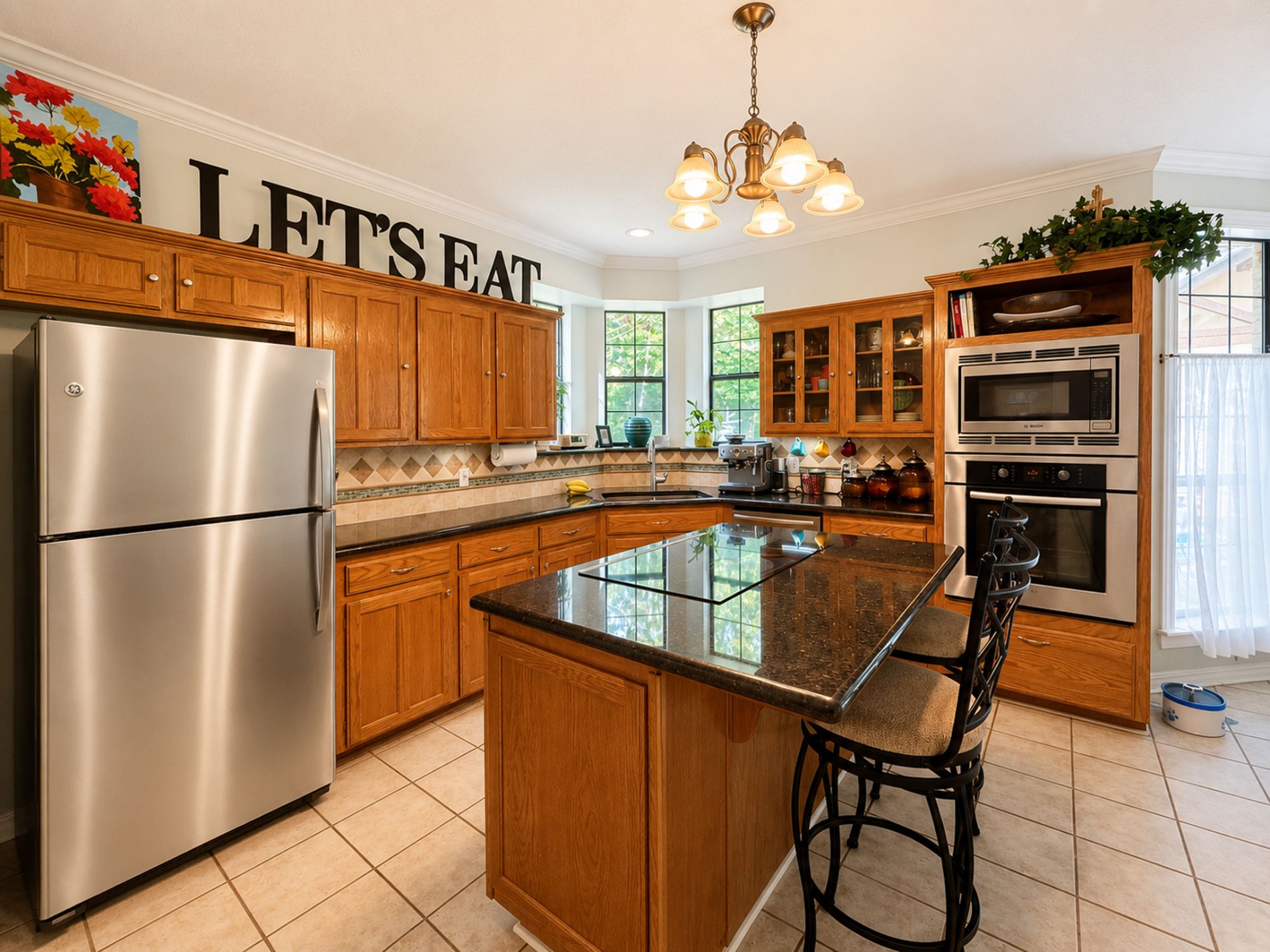 The Kitchen features stainless steel Bosch appliances (oven, microwave, dishwasher), GE Profile induction cooktop, and granite countertops 